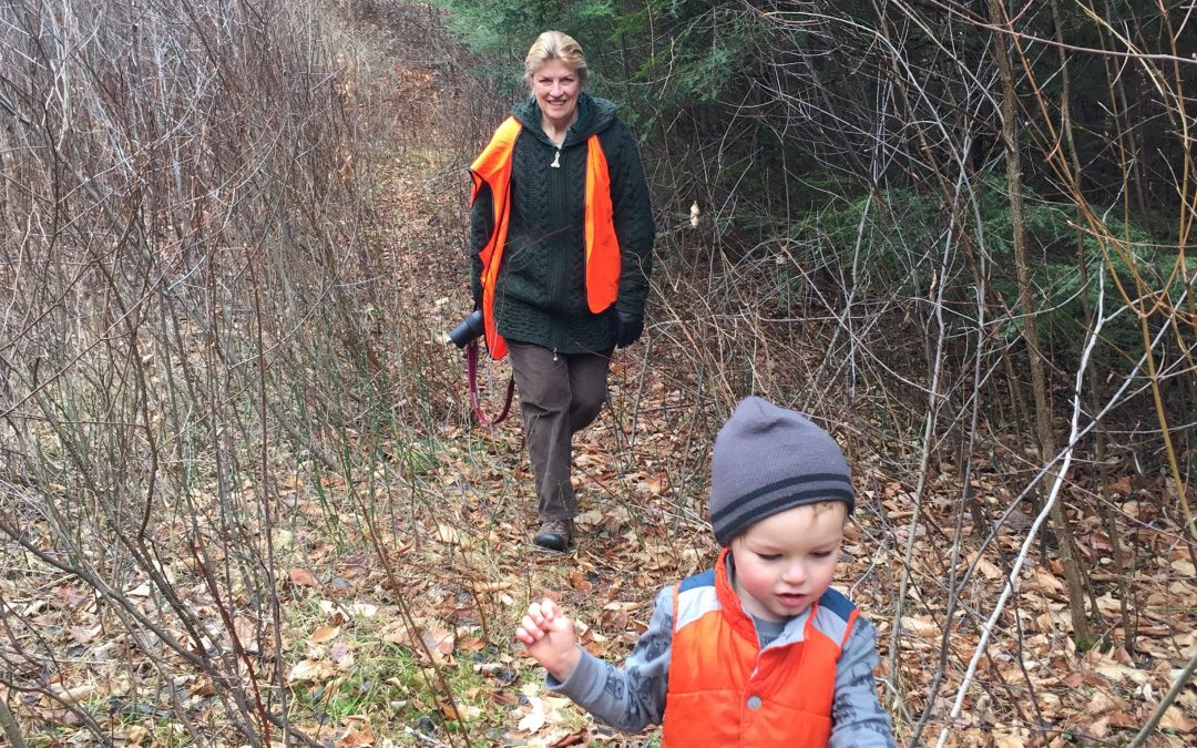 Cheryl Charles and a small boy walking in a forest