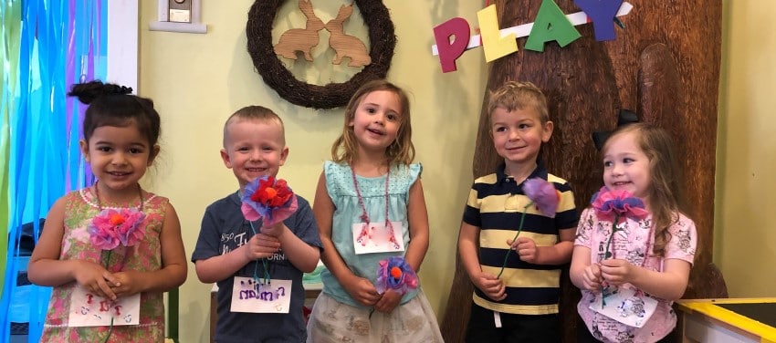 Children holding paper flowers